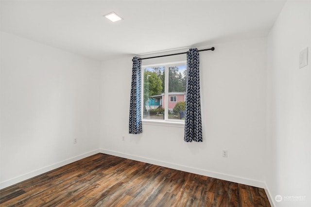 spare room featuring dark hardwood / wood-style flooring