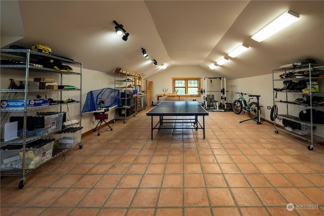 game room featuring lofted ceiling and light tile patterned floors