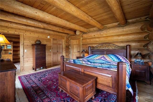 bedroom with light hardwood / wood-style floors, beam ceiling, rustic walls, and wood ceiling