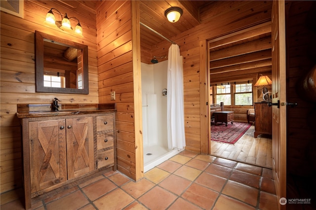 bathroom featuring tile patterned flooring, a shower, wood ceiling, and vanity