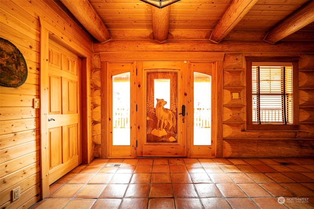 foyer featuring beamed ceiling, wooden ceiling, and a wealth of natural light