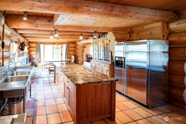 kitchen featuring wood ceiling, log walls, stainless steel fridge, and light tile patterned floors