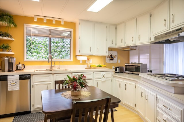 kitchen with white cabinetry, sink, track lighting, and appliances with stainless steel finishes