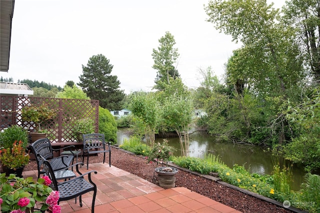 view of patio with a water view