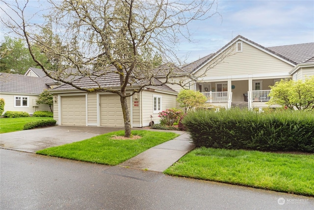 single story home with a porch, a garage, and a front lawn