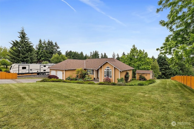 ranch-style house featuring a front lawn and a garage