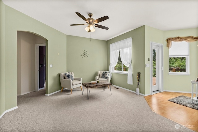 sitting room featuring light carpet and ceiling fan