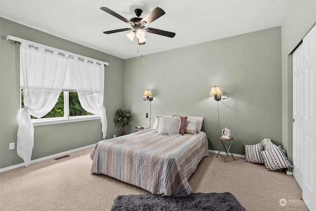 bedroom featuring ceiling fan, a closet, and carpet floors