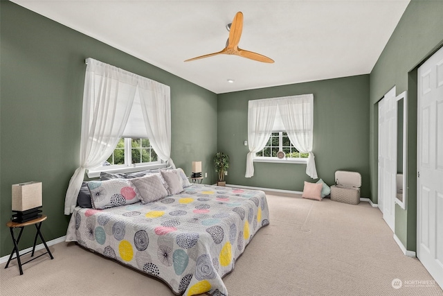 carpeted bedroom featuring ceiling fan