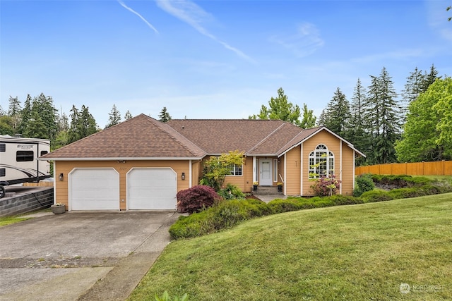 ranch-style home with a garage and a front lawn