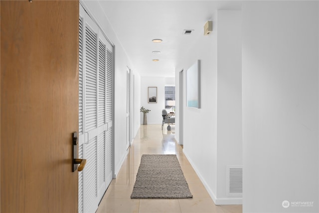 hallway featuring light tile patterned floors