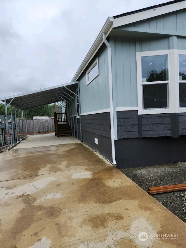 view of side of home with a carport