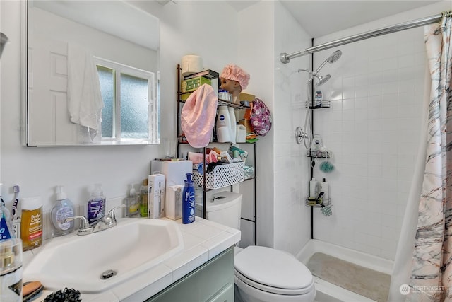 bathroom with vanity, toilet, and walk in shower