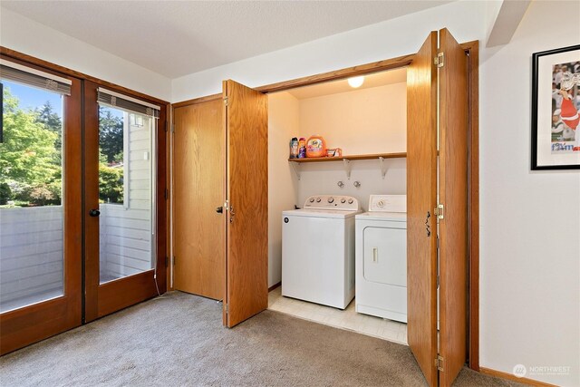 laundry area featuring light colored carpet, french doors, and independent washer and dryer