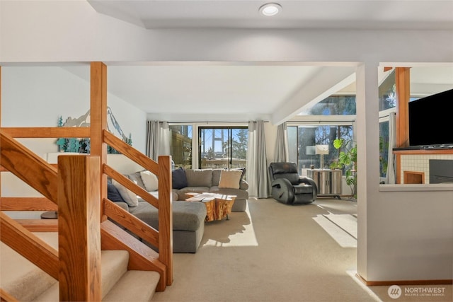 interior space featuring radiator, a tiled fireplace, and carpet floors