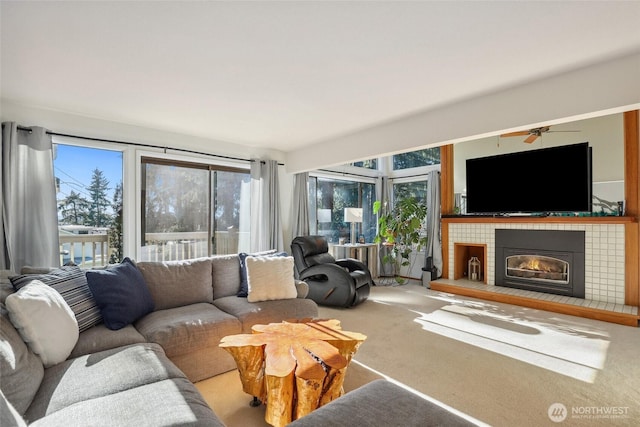 carpeted living room with a tiled fireplace