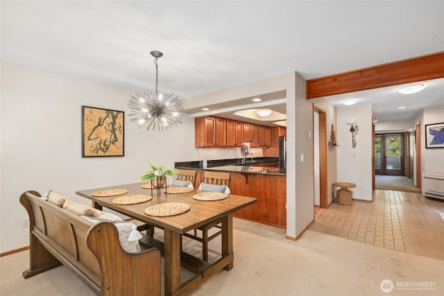 carpeted dining area with a notable chandelier