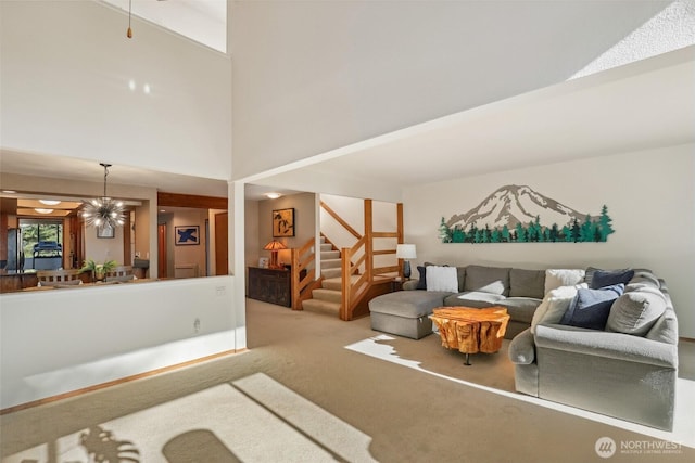 carpeted living room with a high ceiling and a notable chandelier