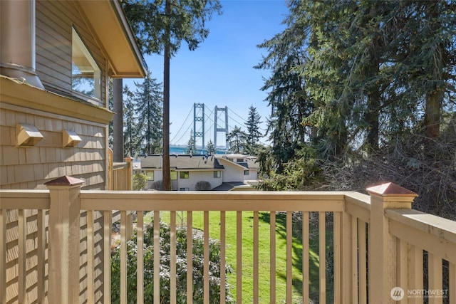 wooden terrace featuring a yard