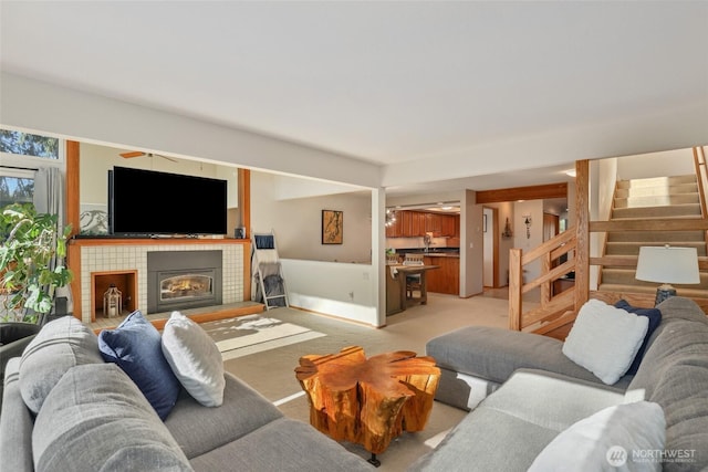 living room with light colored carpet and a fireplace