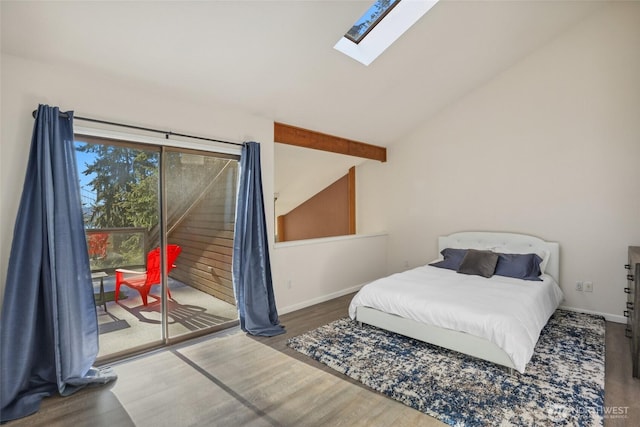 bedroom featuring hardwood / wood-style flooring, lofted ceiling with skylight, and access to outside