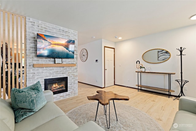 living room featuring a fireplace and light hardwood / wood-style flooring