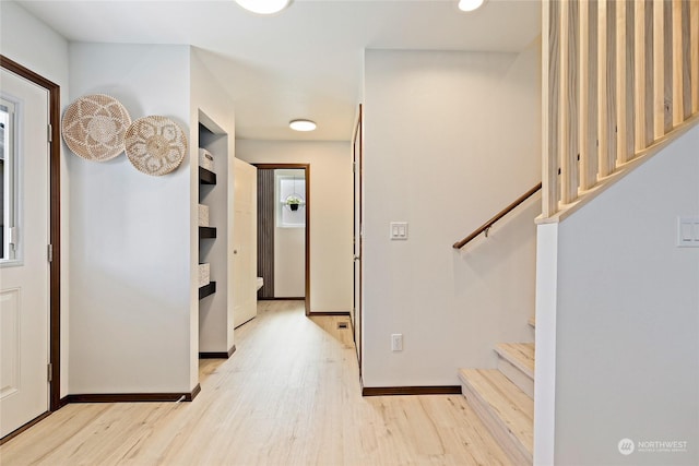 corridor with light hardwood / wood-style flooring