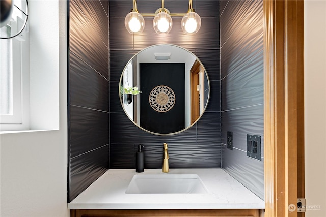 bathroom featuring vanity and tile walls