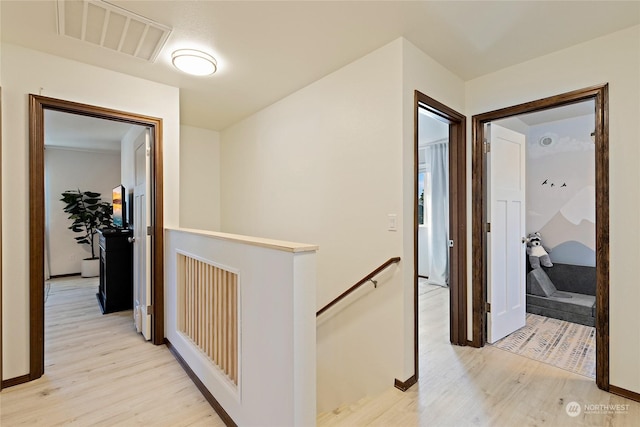 hallway with light hardwood / wood-style flooring