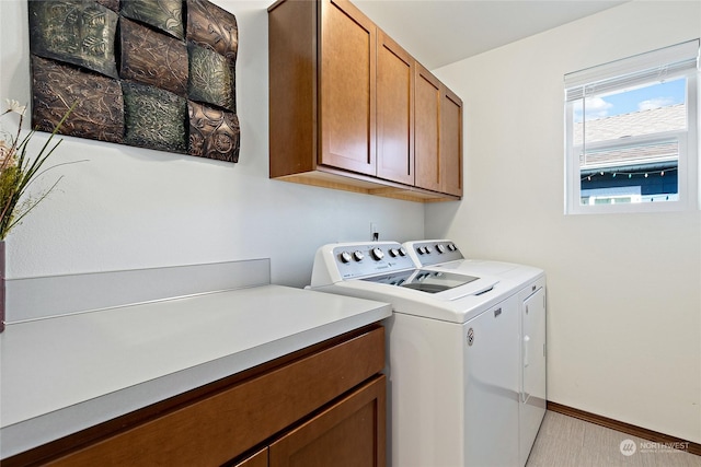 laundry area with cabinets and washing machine and clothes dryer