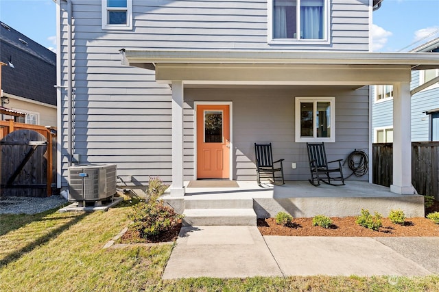 property entrance featuring a porch and central AC