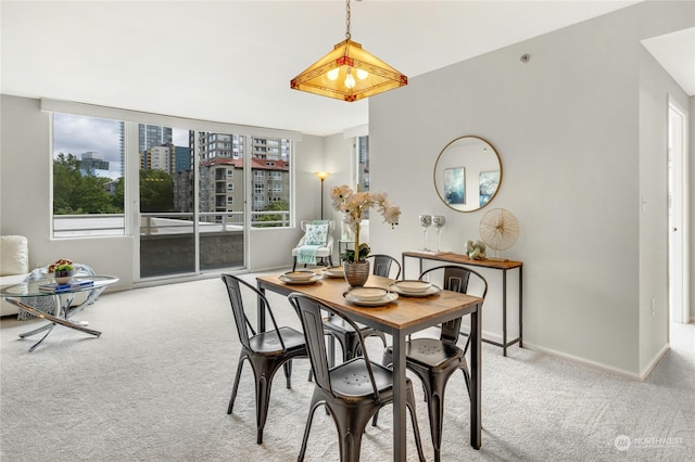 dining room featuring light carpet and plenty of natural light