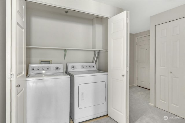 washroom featuring independent washer and dryer and light colored carpet