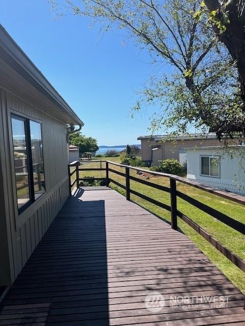 wooden deck featuring a yard