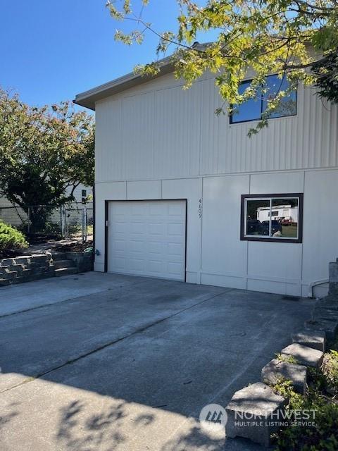 view of side of property with concrete driveway