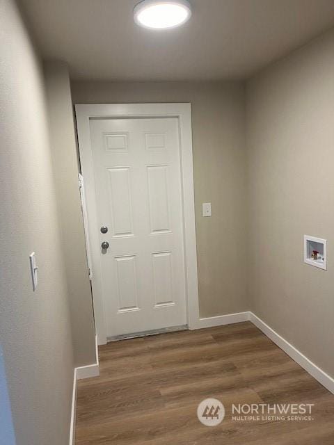 entryway featuring baseboards and wood finished floors