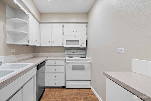 kitchen with dark wood-style floors, white appliances, light countertops, and white cabinetry