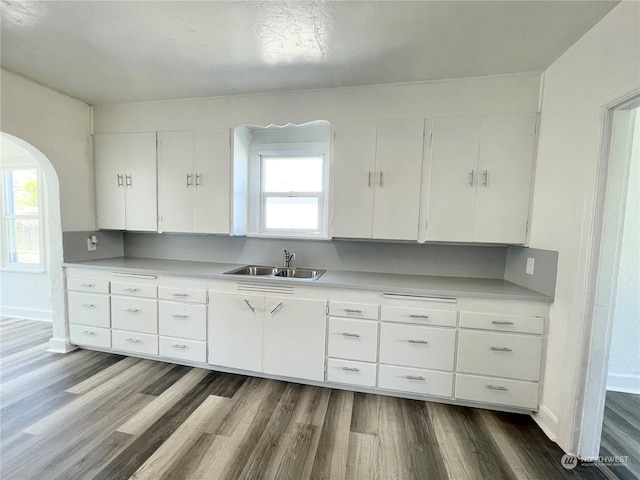 1579 2nd Ave N, Okanogan, WA 98840 - kitchen featuring a sink, wood finished floors, arched walkways, and healthy amount of natural light