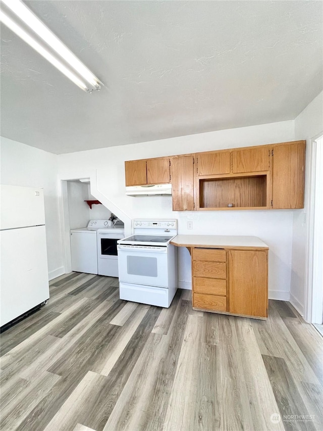 1579 2nd Ave N, Okanogan, WA 98840 - kitchen featuring white appliances, under cabinet range hood, light wood-style flooring, washing machine and dryer, and light countertops