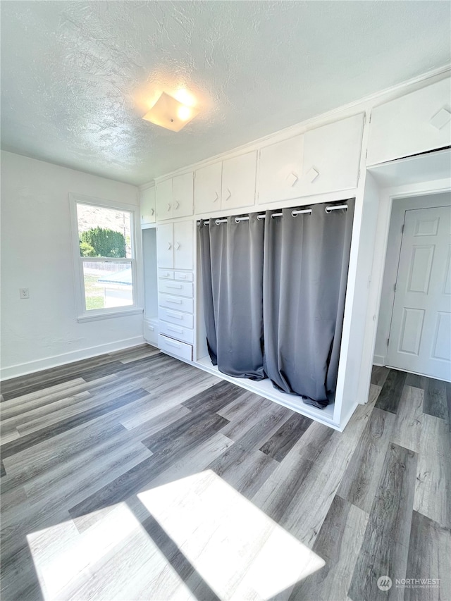 interior space featuring a textured ceiling and dark hardwood / wood-style flooring