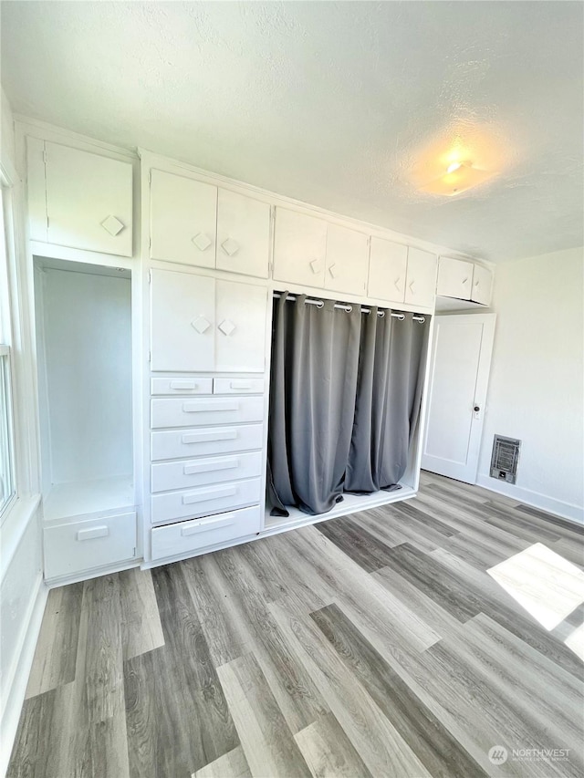 1579 2nd Ave N, Okanogan, WA 98840 - unfurnished bedroom featuring light wood-style floors, a textured ceiling, and baseboards
