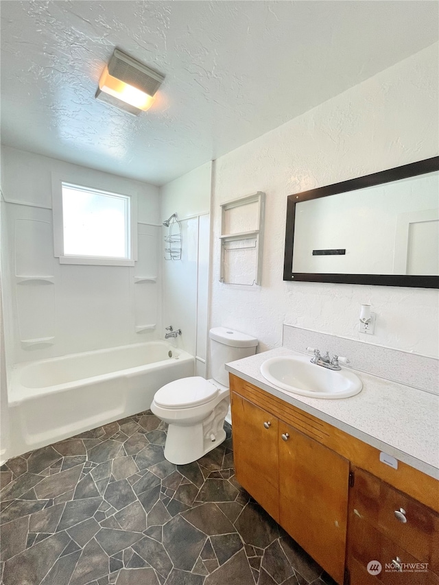 full bathroom featuring oversized vanity, toilet, tile floors, shower / tub combination, and a textured ceiling