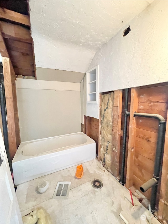 bathroom with lofted ceiling