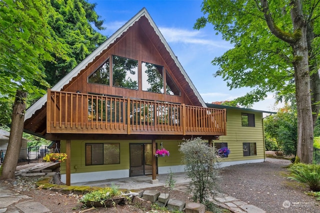 rear view of house with a wooden deck