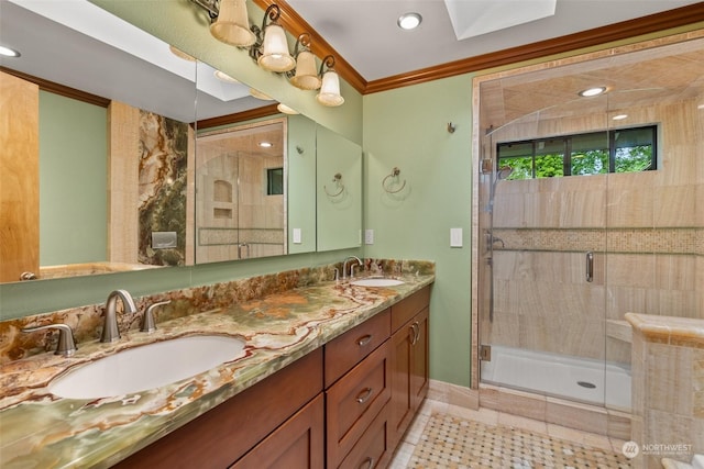 bathroom with crown molding, a shower with door, tile patterned flooring, a skylight, and vanity