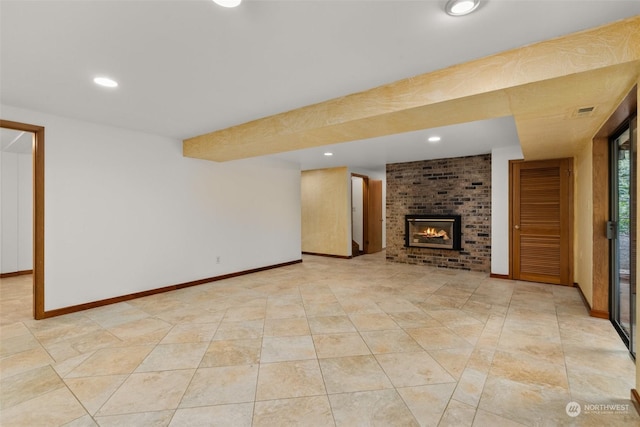 unfurnished living room featuring a brick fireplace