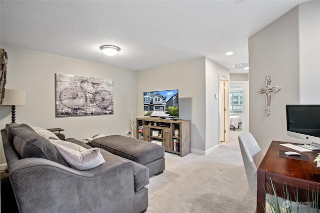 carpeted living room featuring a textured ceiling