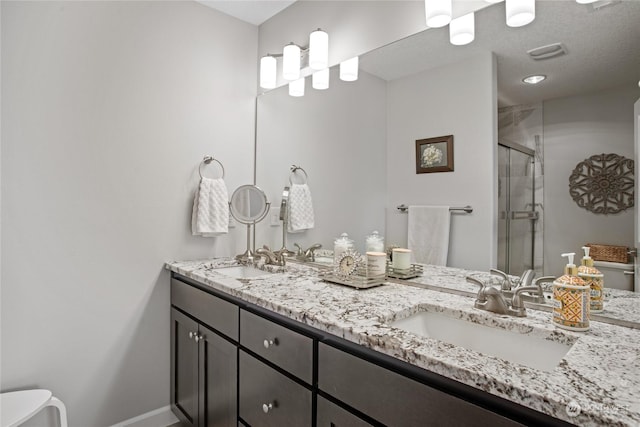 bathroom featuring vanity and a shower with door