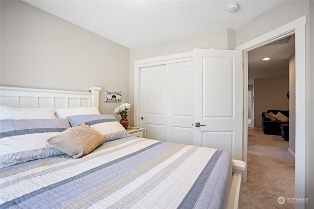 carpeted bedroom featuring a closet