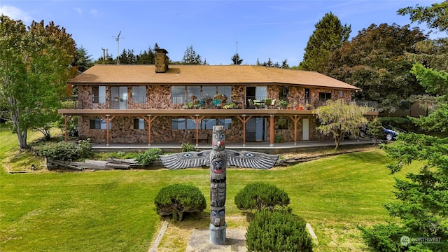 back of house featuring a yard and a patio